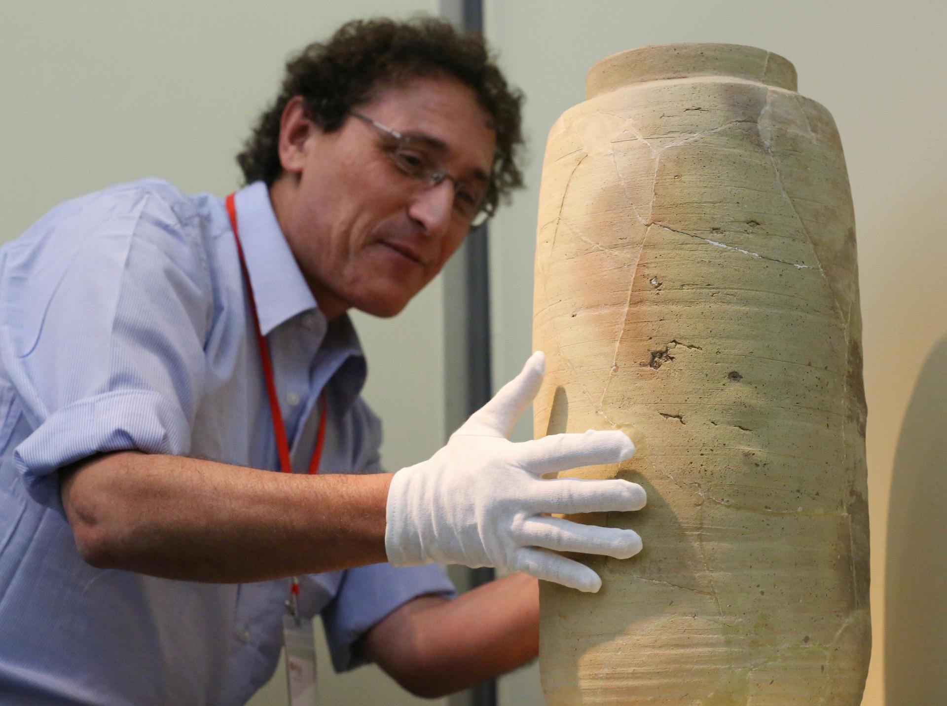 Dr. Adolfo Roitman, Curator of the Dead Sea Scrolls at The Israel Museum, Jerusalem shows the Scroll Jar during media preview of Temple, Scrolls and Divine Messengers: Archeology of the Land of Israel in Roman Times at Asia Society Hong Kong Center in Admiralty. 30OCT14