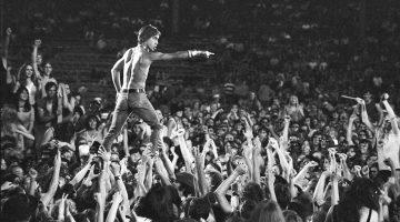 CINCINNATI - JUNE 23: Iggy Pop of the Stooges rides the crowd during a concert at Crosley Field on June 23, 1970 in Cincinnati, Ohio. (Photo by Tom Copi/Michael Ochs Archive/Getty Images)